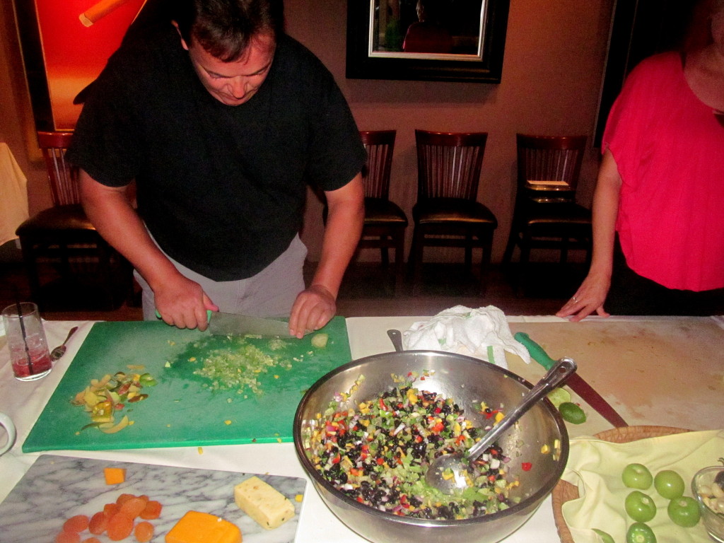 The men cut the veggies in this kitchen.